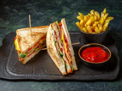 front-view-tasty-ham-sandwiches-with-french-fries-dark-surface