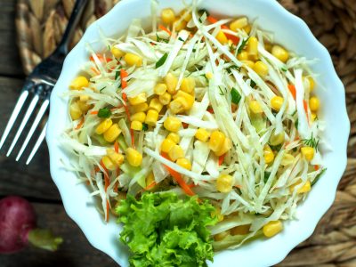 top view light coleslaw with corn lettuce and radish